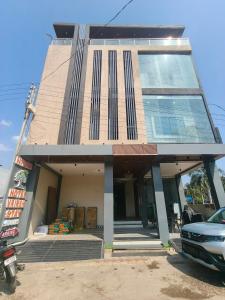 a building with a car parked in front of it at Hotel Vriksh Stay in Godarpura +25 photos