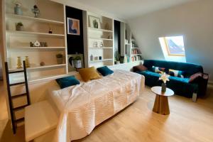 a living room with a bed and a couch at AppartCosy 15 in Vitré