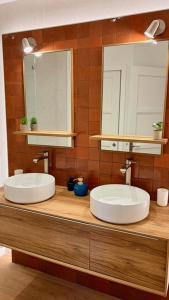 two sinks on a wooden counter with a mirror at AppartCosy 15 in Vitré +22 photos