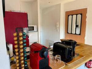 a kitchen with a counter with a coffee maker and a toaster at EasyHome 23 in Vitré