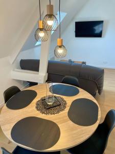 a dining room with a table and a couch at EasyHome 23 in Vitré