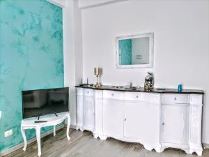 a living room with a tv and a white cabinet at Anzio paradise in Anzio +37 photos
