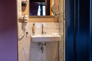 a bathroom with a sink and a mirror at Bakery Boutique Hotel in Leeuwarden +26 photos