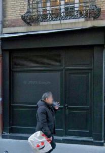 a man walking down the street with a bag of food at Suite Jacuzzi & Sauna privatifs - Paris - Or Norme By Le Douze in Paris