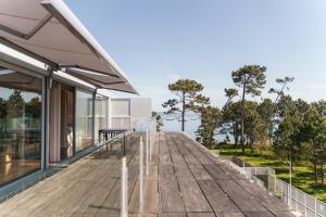 a wooden deck on the side of a house at Santi Cabodeiro in Isla de Arosa