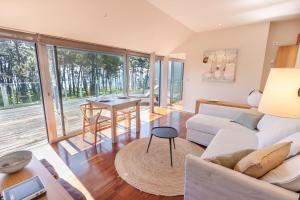 a living room with a white couch and a table at Santi Cabodeiro in Isla de Arosa