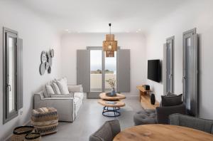 a living room with a couch and a table at La Ponta Villas & Suites in Akrotiri