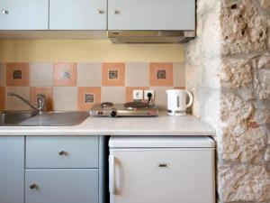 a kitchen with a sink and a counter top at Mandilada Family Village - Seaview Villas in Marathokampos +40 photos