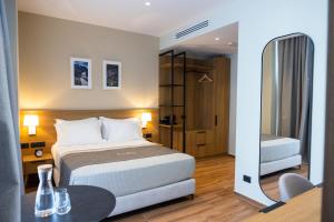 a hotel room with a bed and a table and a bedroom at Mece Hotel Tirana in Tirana