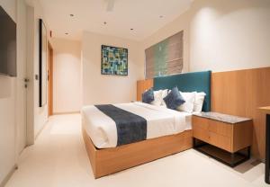a bedroom with a large bed and a television at Airotel in Pune +33 photos
