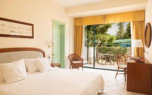 a bedroom with a bed and a view of a patio at Hotel Sierra Silvana in Selva di Fasano +17 photos