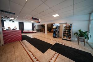 a lobby with a soda machine and black rugs at Hotel Mezaparks in Riga +50 photos