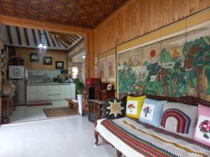 a bedroom with a large painting on the wall at Shine Wolyeong in Andong