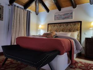 a bedroom with a large bed and a chair at Boutique Chalet in Calheta in Arco da Calheta +24 photos