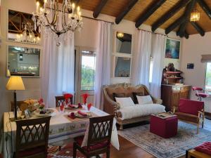 a living room with a table and a couch at Boutique Chalet in Calheta in Arco da Calheta