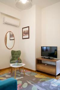 a living room with a tv and a table at Apartman VIK in Brzeće