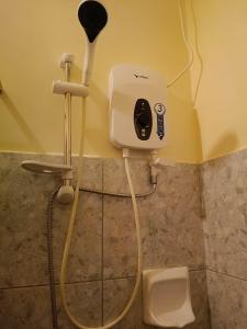 a bathroom with a hair dryer and a toilet at Little Haven at Lio in El Nido