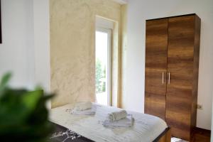 a bedroom with a bed with two towels on it at Apartman VIK in Brzeće