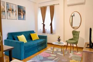 a living room with a blue couch and a chair at Apartman VIK in Brzeće