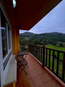 a balcony with benches and a view of the mountains at Fuerte El Mazo in El Dueso
