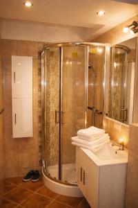 a bathroom with a shower and a sink at Jopi Hostel Katowice Centrum in Katowice +49 photos