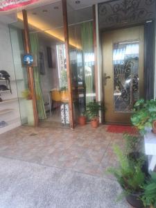 a front door of a house with potted plants at House of love in Xiaoliuqiu