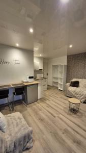 a large room with a desk and a bed at Studio Margny in Margny