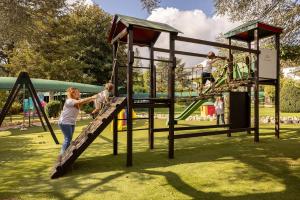 two children playing on a slide at a playground at Hotel Sierra Silvana in Selva di Fasano