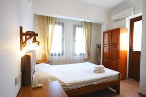 a bedroom with a bed and a table and window at The Dalyan's in Dalyan +36 photos