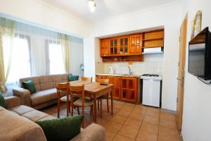 a kitchen and living room with a table and a couch at The Dalyan's in Dalyan