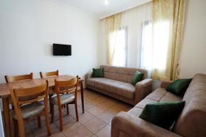 a living room with a couch and a table and a couch and a dining room at The Dalyan's in Dalyan