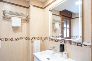 a bathroom with a sink and a mirror at Apartamentos GO - Simancas in Simancas +33 photos