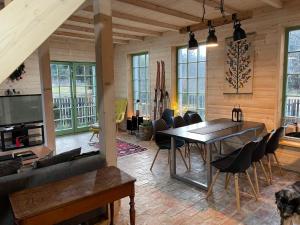 a living room with a dining room table and chairs at Dom Galicja in Radziechowy