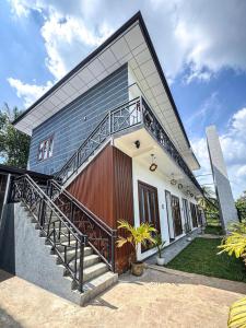 a house with a staircase in front of it at Muthugala Resort in Anuradhapura