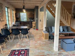 a living room with a couch and a table and chairs at Dom Galicja in Radziechowy