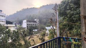 a view of a city from a balcony of a building at vishranti homestayy in Rishīkesh