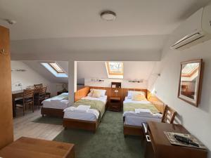 a room with three beds and a dining room at A-Termal Palić in Palić +133 photos