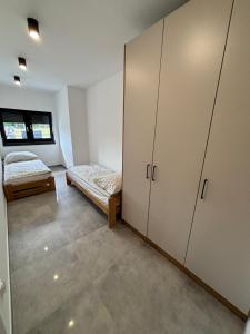 a room with two beds and cabinets in it at Nocleg Szwed-Pol in Jastrowie