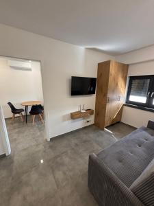 a living room with a couch and a tv and a table at Nocleg Szwed-Pol in Jastrowie