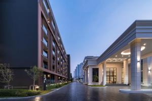 an empty street between two tall buildings at night at Mandarin Eastville, Pattaya - SHA Extra Plus in North Pattaya