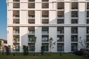 an apartment building with balconies on the side at Mandarin Eastville, Pattaya - SHA Extra Plus in North Pattaya