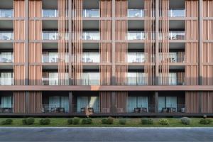 an external view of a tall building with windows at Mandarin Eastville, Pattaya - SHA Extra Plus in North Pattaya +102 photos