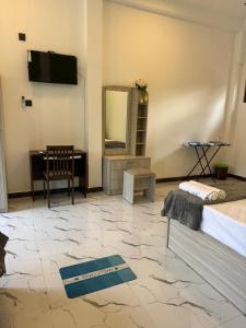 a bedroom with a bed and a mirror and a desk at Muthugala Resort in Anuradhapura
