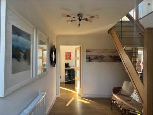 a hallway with a ceiling fan and a staircase at Seaview in Lowestoft