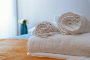 a stack of towels sitting on top of a table at Blue House Ponte de Lima in Ponte de Lima