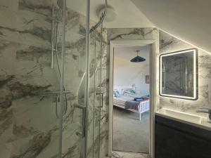 a bathroom with a walk in shower next to a sink at Seaview in Lowestoft +34 photos
