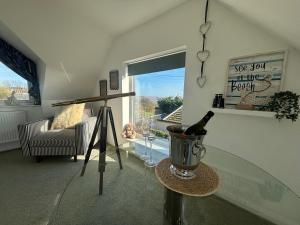 a room with a glass table and a bottle of wine at Seaview in Lowestoft