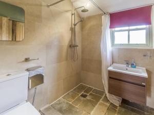 a bathroom with a shower and a sink at Orchard Cottage in Durham +8 photos