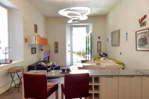 a kitchen and living room with a table and chairs at Casa Julia - Menaggio by LoveComo in Menaggio