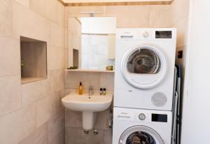 a bathroom with a washing machine and a sink at Casa Julia - Menaggio by LoveComo in Menaggio
